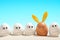 White eggs, looking the brown tanned with rabbit ears. Easter on the beach concept.