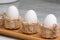 White eggs in three small baskets on kitchen counters