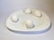 White eggs on a white plate on a white background. The birth of life. 4 Chicken eggs