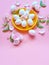 White Eggs on Yellow plate flowers  On Pink Background Ester Holiday Background Concept