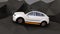 White electric SUV driving on geometric hard surface ground