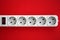 White electrical multi plug extender with european socket on bright red background