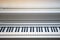 White electronic grand piano  hybrid synthesizer keys close up