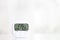 White electronic hygrometer on white table