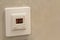 White electronic programmable digital thermostat on light wall copy space background. Climate control, comfortable home