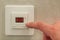 White electronic programmable digital thermostat on light wall copy space background. Climate control, comfortable home