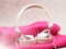 White elegant headphones on a pink scarf