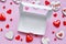 white empty box for delivery of muffins, cookies, cakes on pink background for restaurants for valentines day. red hearts of