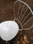 White empty chair on small brown pebbles ground in garden