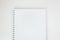 White empty paper notebook with spiral on white desk, top view. Mockup clean sheet