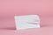 White empty rectangle with incised stripes on pink background. Random scissor-cut slip of paper on colored background with shadows