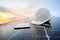 White engineer hard hat and a tablet placed on the solar panel At a photovoltaic power station working on solar energy storage in