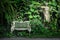 white europe style bench against forest back ground with a statue