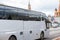 White excursion bus moves in the center of Moscow