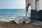 White facade house next to boat on the beach