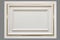 White facade panel with golden moulding isolated on gray background