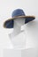 White faceless mannequin in a straw hat. Mannequin in the store