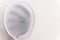 a white fan blows against the background of a white wall. A fan with a grid is located at home in office and cools