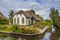 White farm house with thatched roof in Giethoorn
