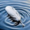 White Feather Floating On Rippled Blue Water