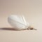 A white feather laying on top of a table. Generative AI image.