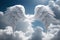 White feathered angel wings on a background of blue sky and clouds