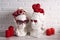 White female and male plaster heads with heart shaped glasses, hearts, flowers and candles against the white brick wall