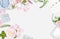 White feminine background. Flat lay. Pink roses, petals, mirror, green leaves, gift, bag. Place for text. Cheerful mind every