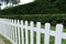 White fence and green grass in park