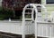 White fence with starfish cut outs and arbor at coast