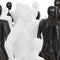 A white figure of a man made of plastic against a background of black and white mannequins. 3d rendering
