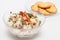 White fish Peruvian ceviche served in a transparent bowl with crackers
