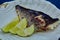 The white fish on plate with lime. Kosher food. Shallow dof.