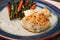 White flakey sea bass with breadcrumbs and roasted asparagus and