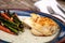 White flakey sea bass with breadcrumbs and roasted asparagus and