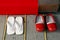 White flip-flops and red clogs