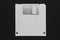 White floppy disk on black background