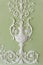 White floral plaster bas-relief on the green wall. Classic decorative pattern