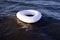 white flotation ring on blue sea,