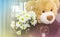 White flower bouquet with cute bear doll gift background