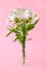 White flowers of alstroemeria, commonly called the Peruvian lily or lily of the Incas in a small transparent glass vase on a