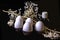 White flowers with white eggs and small black bottle and seashells on a black background