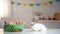 White fluffy bunny sitting table near basket decoration, Easter symbol, spring