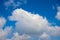 White fluffy cloud on blue sky background. Cloudscape photo background.