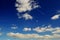 White, fluffy clouds in blue sky. Background from clouds.with airplane vapour trail