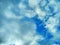 White fluffy clouds in the blue sky. Beautiful nature and outdoor view with white cloud on blue sky background