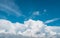 White fluffy clouds on blue sky. Soft touch feeling like cotton. White puffy clouds cape with space for text. Beauty in nature.