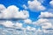 White fluffy clouds on clear sunny blue sky background closeup, cumulus cloud texture, cloudy skies, cloudiness, cloudscape heaven