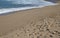 WHITE FOAMY SEAWATER PUSHING OUT ONTO BEACH