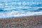 The white foamy waves on the pebble stones of the Mediterranean in Konyaalti Beach.